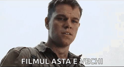 A Close Up Of A Man 'S Face With The Words Filmul Asta E Vechi Written Below Him . GIF