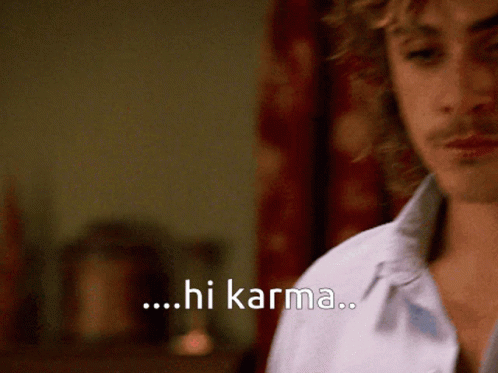 A Close Up Of A Man 'S Face With The Words Hi Karma Behind Him GIF