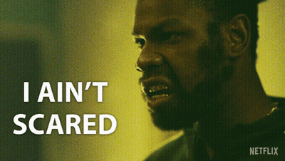 A Close Up Of A Man 'S Face With The Words " I Ain 'T Scared " Above Him GIF