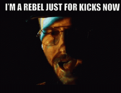 A Close Up Of A Man 'S Face With The Words `` I 'M A Rebel Just For Kicks Now '' . GIF