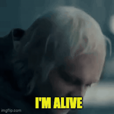 A Close Up Of A Man 'S Face With The Words I 'M Alive Written On It GIF