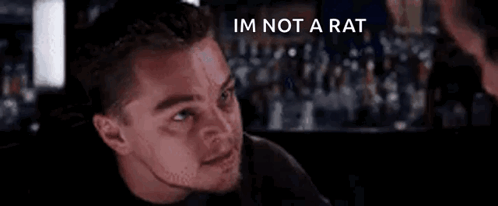 A Close Up Of A Man 'S Face With The Words `` I 'M Not A Rat '' Written On It . GIF