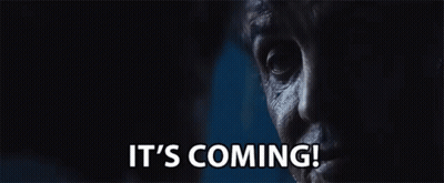 A Close Up Of A Man 'S Face With The Words It 'S Coming Written Below It GIF