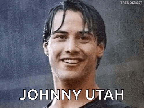 A Close Up Of A Man 'S Face With The Words Johnny Utah Written On It GIF