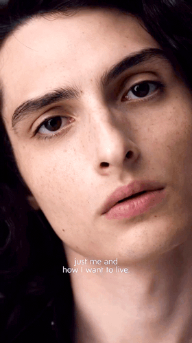 A Close Up Of A Man 'S Face With The Words Just Me And How I Want To Live Written Below It GIF