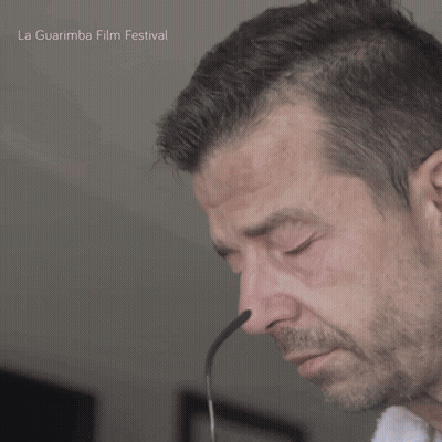 A Close Up Of A Man 'S Face With The Words La Guarimba Film Festival On The Bottom Right GIF