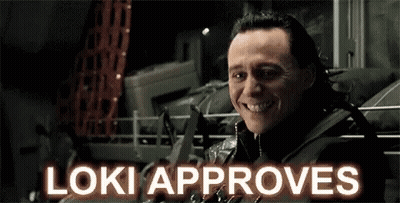 A Close Up Of A Man 'S Face With The Words `` Loki Approves '' Written Above Him . GIF
