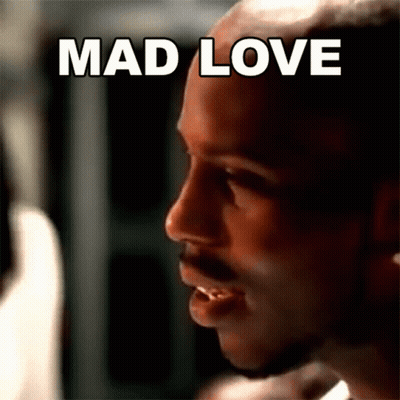 A Close Up Of A Man 'S Face With The Words Mad Love In White Letters GIF