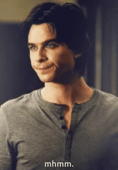 A Close Up Of A Man 'S Face With The Words Mhmm Written Below Him GIF