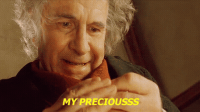A Close Up Of A Man 'S Face With The Words My Preciousss Written In Yellow GIF