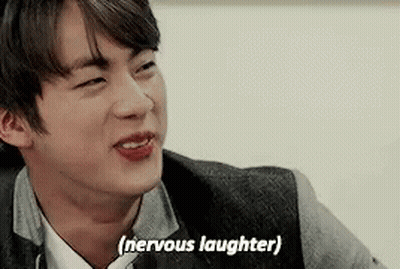 A Close Up Of A Man 'S Face With The Words `` Nervous Laughter '' Written Next To Him . GIF