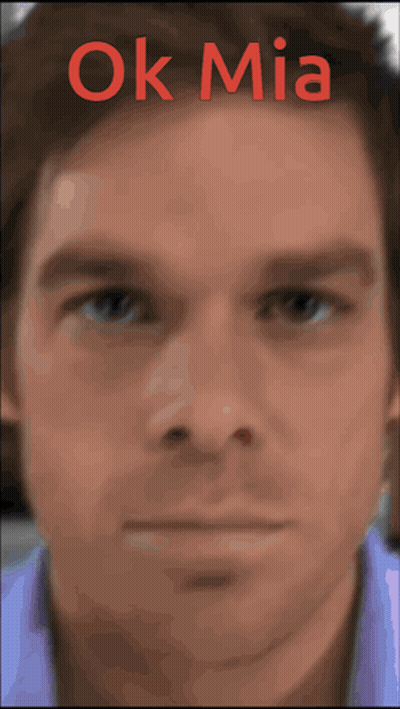 A Close Up Of A Man 'S Face With The Words Ok Mia Written Above It GIF