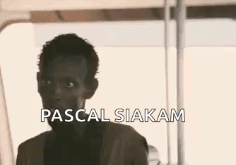 A Close Up Of A Man 'S Face With The Words `` Pascal Siakam '' Written Above Him . GIF