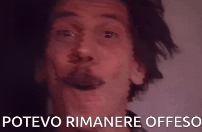 A Close Up Of A Man 'S Face With The Words Potevo Rimanere Offeso Written Below Him GIF