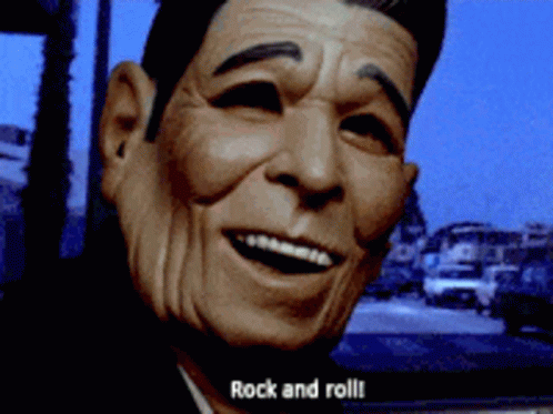 A Close Up Of A Man 'S Face With The Words Rock And Roll Behind Him GIF