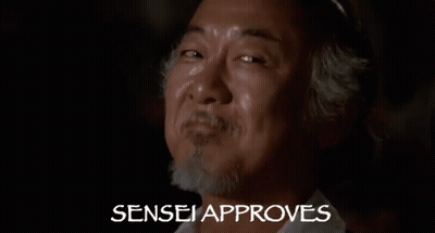 A Close Up Of A Man 'S Face With The Words Sensei Approves Behind Him . GIF