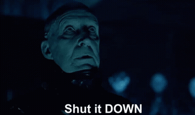 A Close Up Of A Man 'S Face With The Words Shut It Down Written Below It GIF
