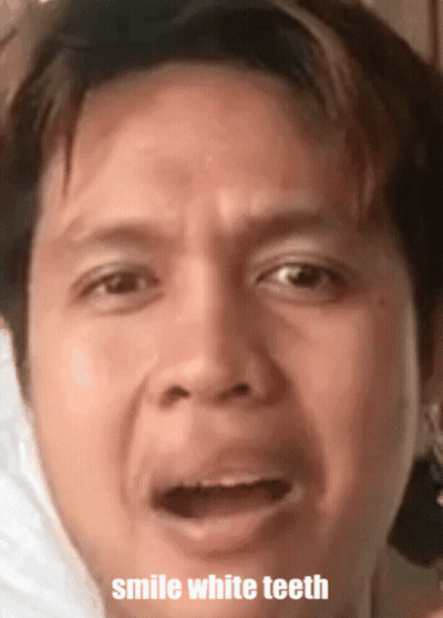 A Close Up Of A Man 'S Face With The Words Smile White Teeth GIF