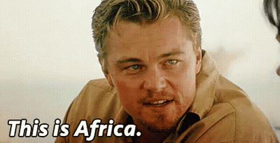 A Close Up Of A Man 'S Face With The Words `` This Is Africa '' Written Below Him . GIF