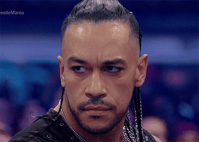 A Close Up Of A Man 'S Face With The Words Wrestlemania In The Corner GIF