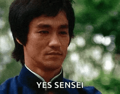 A Close Up Of A Man 'S Face With The Words Yes Sensei Written On It . GIF