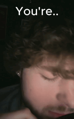 A Close Up Of A Man 'S Face With The Words " You 'Re " Written Above Him GIF
