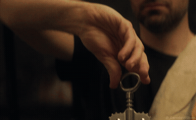 A Close Up Of A Man 'S Hand Holding A Key With The Words Daredevil Shots Below It GIF