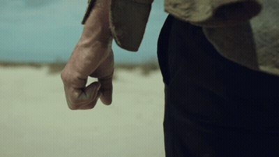 A Close Up Of A Man 'S Hand With A Fist In The Air GIF