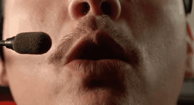A Close Up Of A Man 'S Mouth With A Microphone In It . GIF