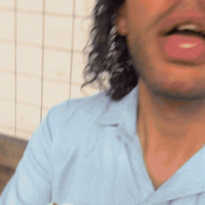 a close up of a man 's mouth with a pink tongue sticking out