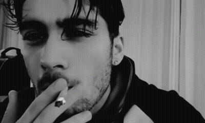A Close Up Of A Man Smoking A Cigarette GIF