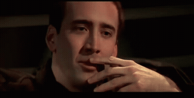 A Close Up Of A Man Smoking A Cigarette In A Car . GIF