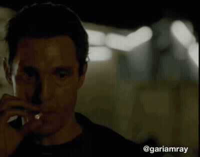 A Close Up Of A Man Smoking A Cigarette With The Hashtag @Gariamray At The Bottom GIF