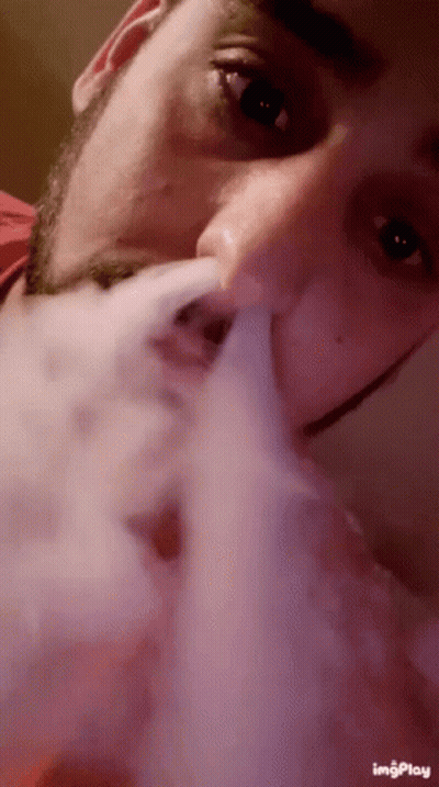 A Close Up Of A Man Smoking A Cigarette With The Words Imgplay On The Bottom Right GIF