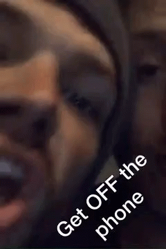 A Close Up Of A Man Talking On A Cell Phone With The Words `` Get Off The Phone '' . GIF