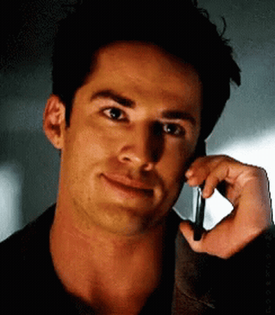 A Close Up Of A Man Talking On A Cellphone GIF