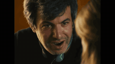 A Close Up Of A Man Talking On A Phone That Says Tesco GIF