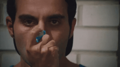 A Close Up Of A Man Using An Inhaler On His Nose GIF