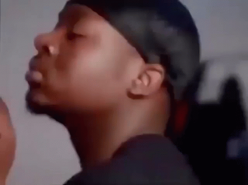 A Close Up Of A Man Wearing A Bandana And A Black Shirt . GIF