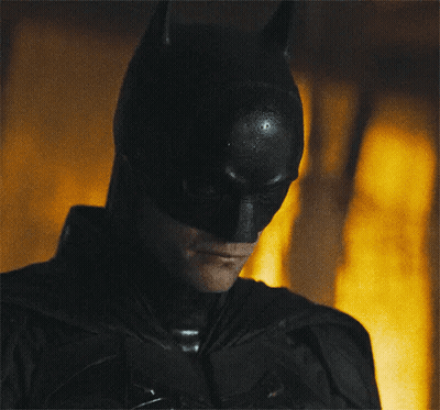 A Close Up Of A Man Wearing A Batman Costume GIF