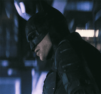 A Close Up Of A Man Wearing A Batman Costume GIF