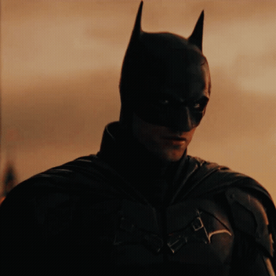 A Close Up Of A Man Wearing A Batman Mask GIF