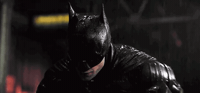 A Close Up Of A Man Wearing A Batman Mask In The Rain . GIF