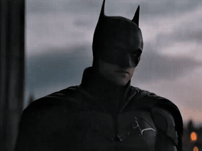 A Close Up Of A Man Wearing A Batman Mask GIF