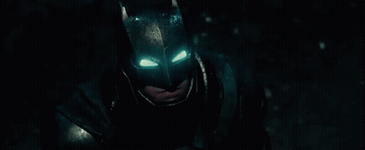 A Close Up Of A Man Wearing A Batman Mask With His Eyes Glowing . GIF