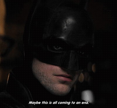 A Close Up Of A Man Wearing A Batman Mask With The Words " Maybe This Is All Coming To An End " GIF