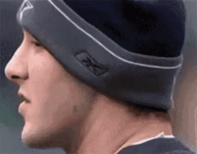 A Close Up Of A Man Wearing A Beanie And A Hat . GIF