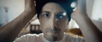A Close Up Of A Man Wearing A Beanie On His Head . GIF