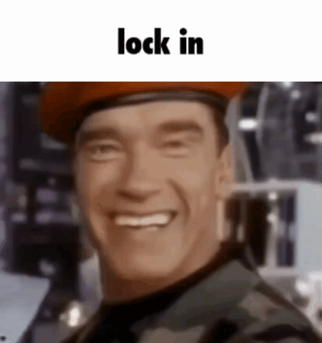 A Close Up Of A Man Wearing A Beret And Smiling With The Words Lock In Below Him . GIF