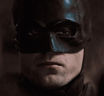 A Close Up Of A Man Wearing A Black Batman Mask GIF